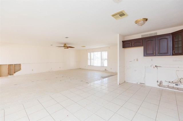 tiled empty room featuring ceiling fan