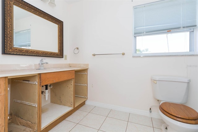 bathroom with tile patterned flooring, vanity, and toilet