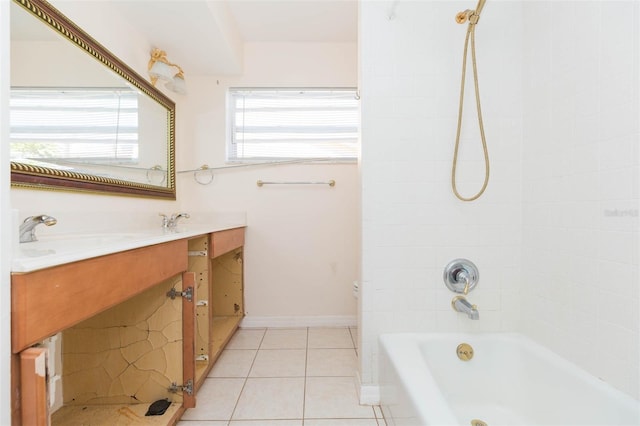 bathroom featuring tile patterned flooring, vanity, and tiled shower / bath