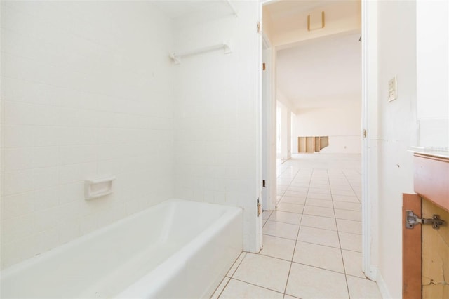 bathroom featuring tile patterned floors and a tub to relax in