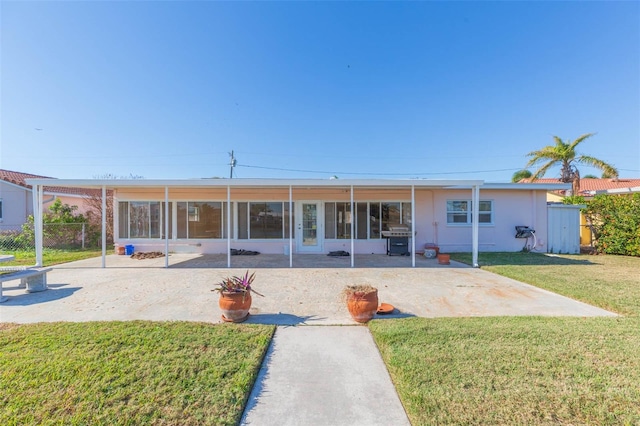 rear view of house with a yard and a patio area