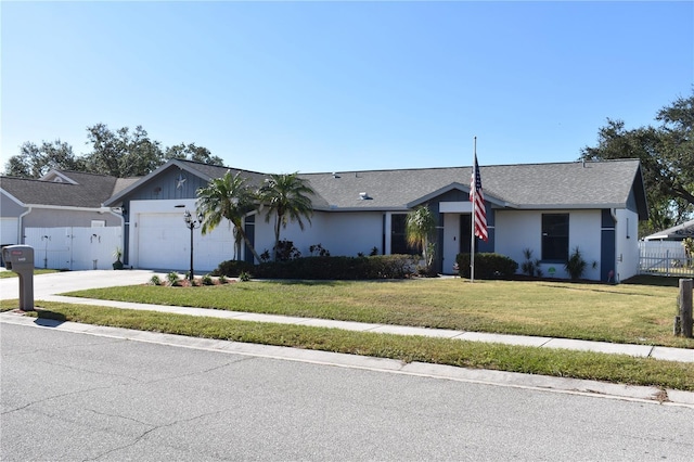 ranch-style home featuring a garage and a front yard