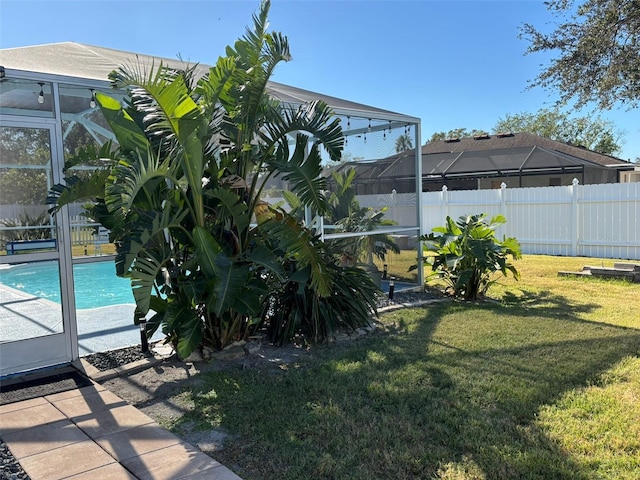 view of yard featuring a fenced in pool and a lanai