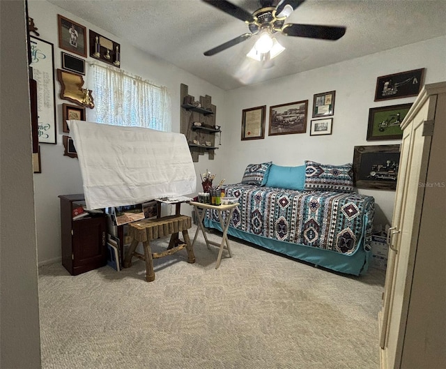 bedroom featuring light carpet, a textured ceiling, and ceiling fan