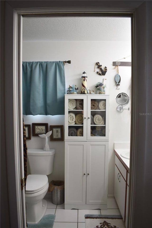 bathroom featuring tile patterned floors, vanity, and toilet