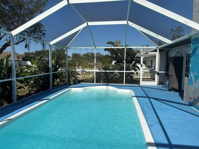 view of pool with glass enclosure