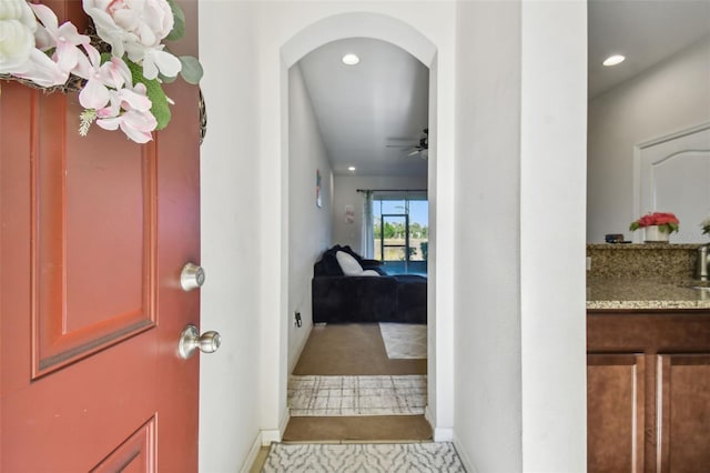 entryway with light tile patterned floors and ceiling fan