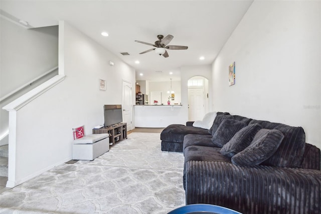 carpeted living room featuring ceiling fan