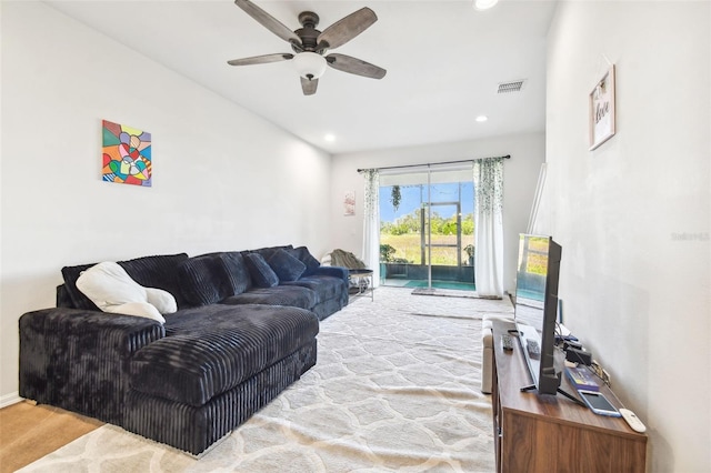 living room featuring hardwood / wood-style flooring and ceiling fan