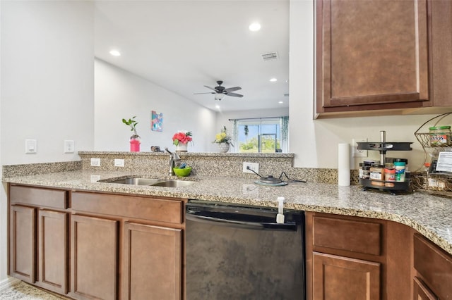 kitchen with kitchen peninsula, light stone counters, stainless steel dishwasher, ceiling fan, and sink