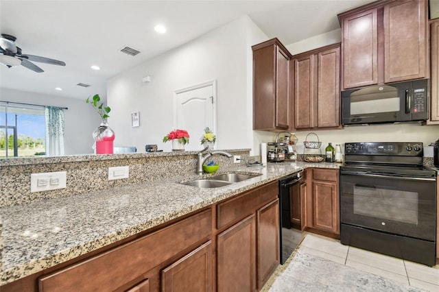 kitchen with black appliances, sink, ceiling fan, light stone countertops, and light tile patterned floors