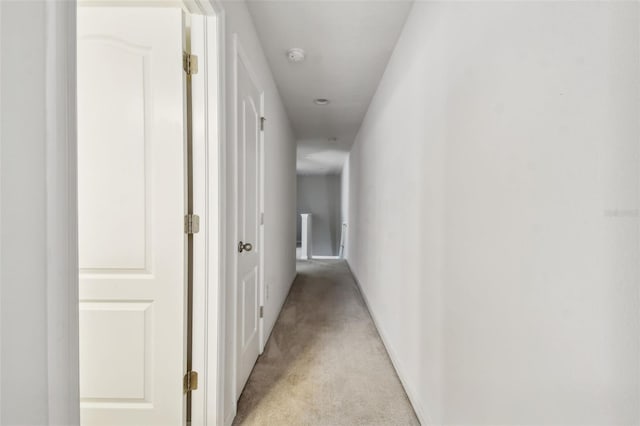 hallway with light colored carpet