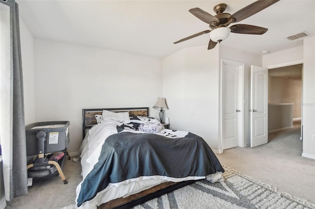 bedroom featuring light carpet and ceiling fan