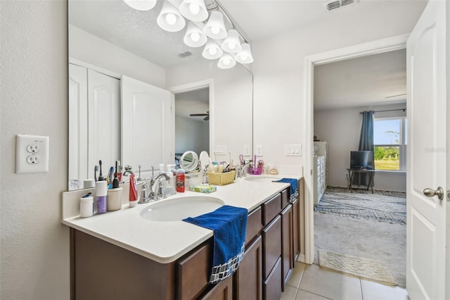 bathroom featuring tile patterned flooring, vanity, and ceiling fan