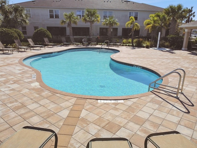 view of swimming pool with a patio