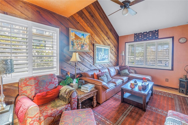 living room with ceiling fan, a healthy amount of sunlight, and lofted ceiling