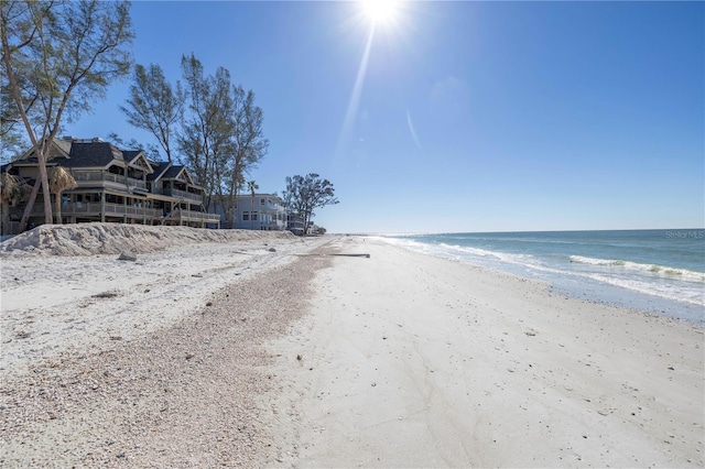 view of street featuring a view of the beach and a water view