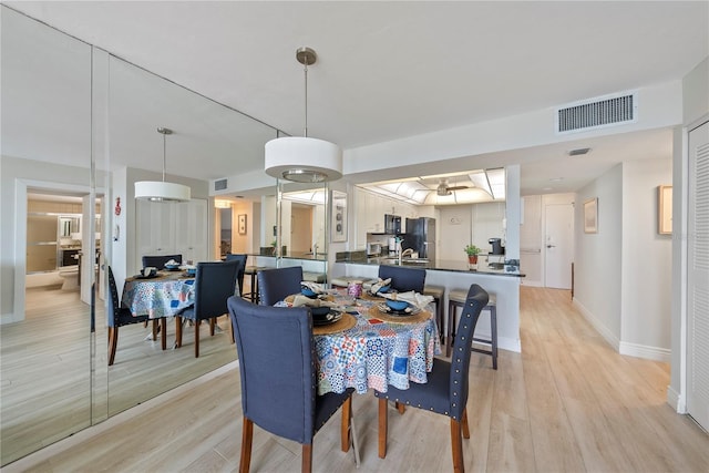 dining space featuring light wood-type flooring