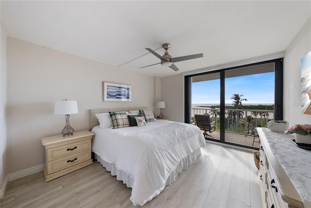 bedroom featuring floor to ceiling windows, light wood-type flooring, access to outside, and ceiling fan