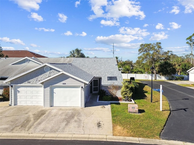 view of front facade with a garage and a front lawn