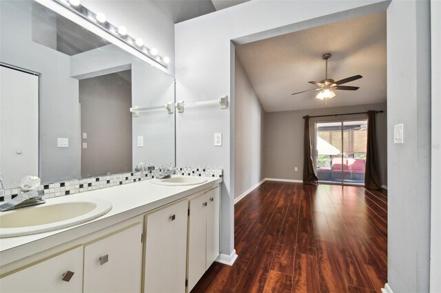 bathroom with ceiling fan, vanity, and wood-type flooring