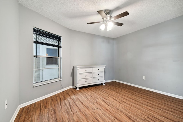 empty room with a textured ceiling, light hardwood / wood-style flooring, and ceiling fan