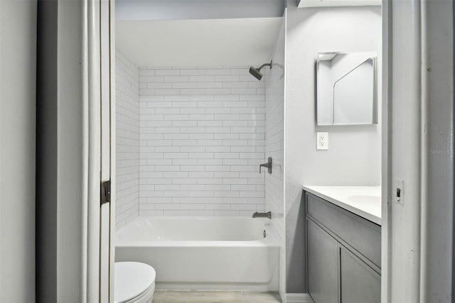 full bathroom featuring tile patterned floors, vanity, toilet, and tiled shower / bath combo