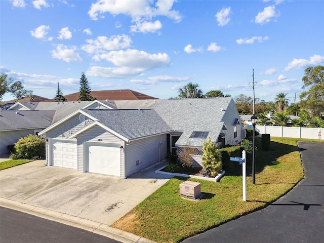 view of front of property with a front yard and a garage