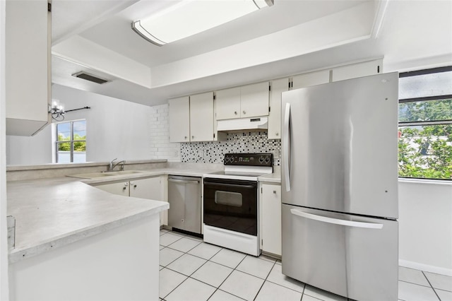 kitchen featuring under cabinet range hood, stainless steel appliances, light countertops, visible vents, and light tile patterned flooring