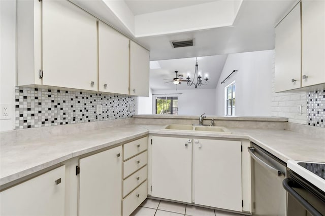 kitchen with stainless steel dishwasher, a sink, visible vents, backsplash, and light countertops