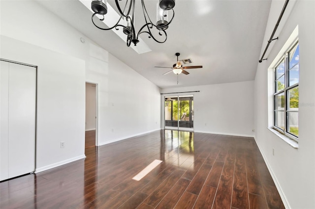 interior space featuring high vaulted ceiling, wood finished floors, baseboards, and ceiling fan with notable chandelier