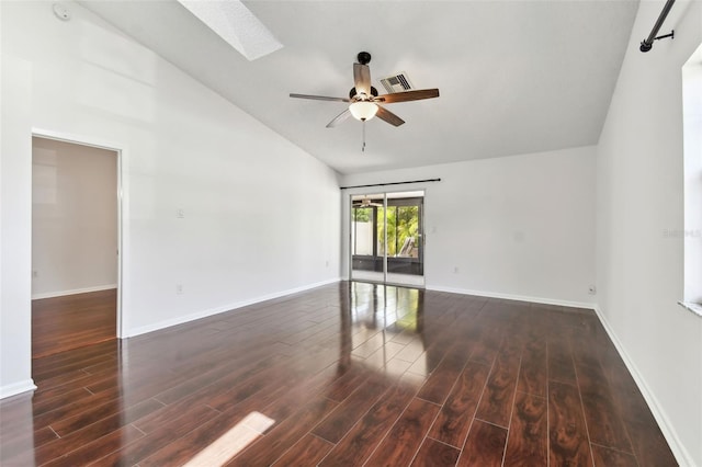 empty room featuring wood finished floors, visible vents, lofted ceiling with skylight, baseboards, and ceiling fan