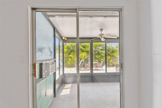 unfurnished sunroom with a ceiling fan
