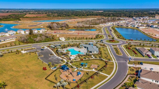 10725 Tippecanoe Pl, Parrish, FL 34219 - aerial overview of property's location featuring a large body of water, a pool, and nearby suburban area