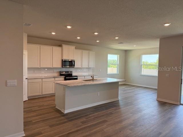 10725 Tippecanoe Pl, Parrish, FL 34219 - kitchen featuring stainless steel microwave, range with electric stovetop, recessed lighting, dark wood-style floors, and decorative backsplash