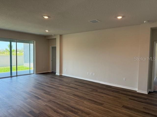 10725 Tippecanoe Pl, Parrish, FL 34219 - empty room featuring baseboards, dark wood-style floors, recessed lighting, and a textured ceiling