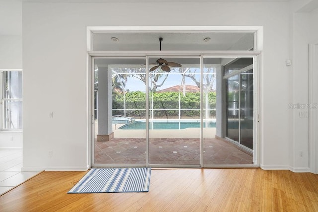 doorway featuring ceiling fan and light wood-type flooring