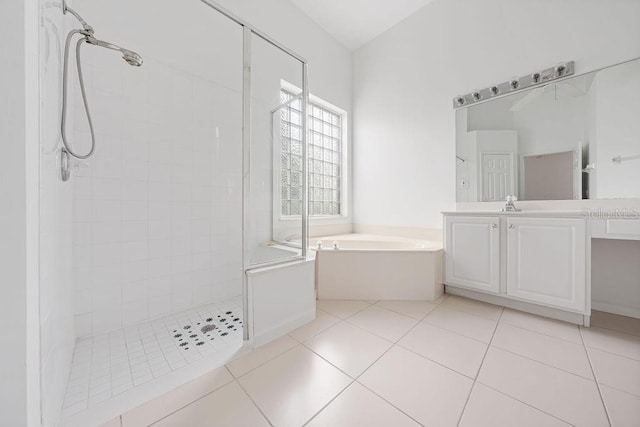 bathroom featuring tile patterned flooring, vanity, and shower with separate bathtub