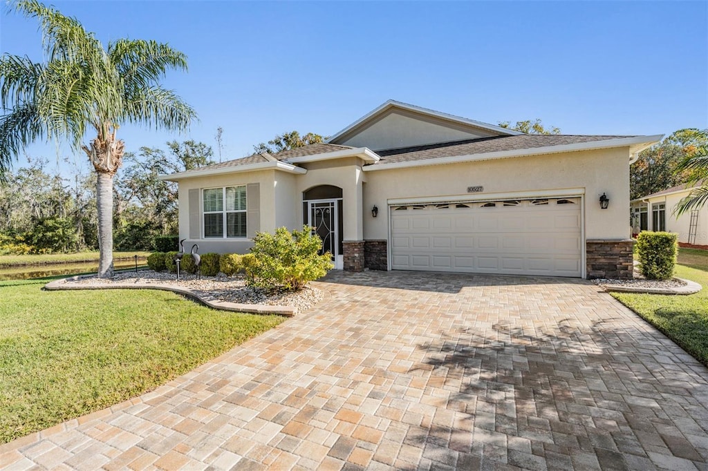 view of front of home with a garage and a front lawn