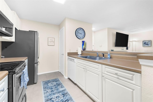 kitchen featuring sink, light tile patterned floors, stainless steel appliances, and white cabinets