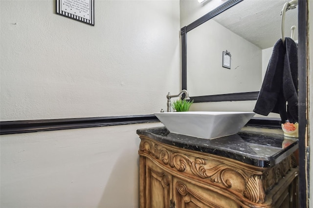 bathroom with vanity and a textured ceiling