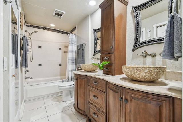 full bathroom featuring tile patterned flooring, vanity, toilet, and shower / bathtub combination with curtain