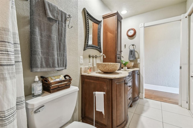 bathroom featuring tile patterned floors, vanity, and toilet