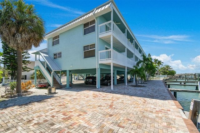 143 94th Ave Unit 2, Treasure Island, FL 33706 - view of property featuring a carport and stairs