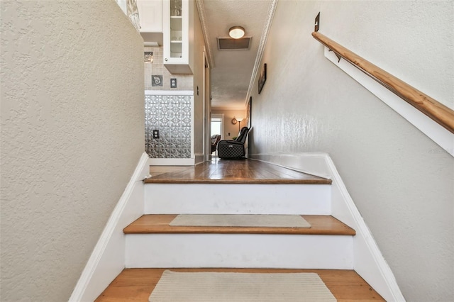143 94th Ave Unit 2, Treasure Island, FL 33706 - stairway featuring wood finished floors and a textured wall