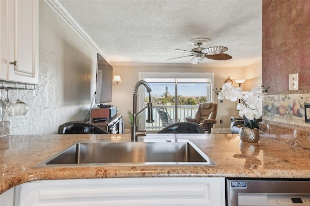 143 94th Ave Unit 2, Treasure Island, FL 33706 - kitchen with dishwasher, a textured ceiling, ornamental molding, ceiling fan, and white cabinets