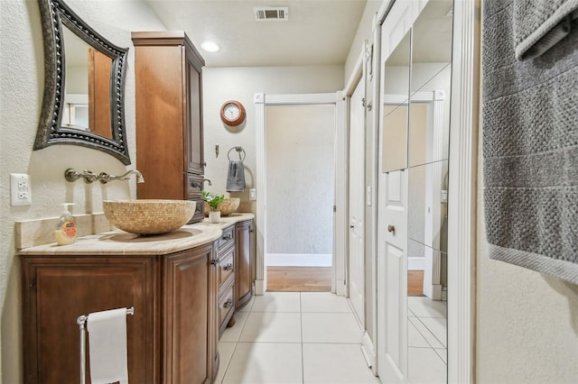 143 94th Ave Unit 2, Treasure Island, FL 33706 - full bathroom with a textured wall, tile patterned floors, vanity, and a shower with door