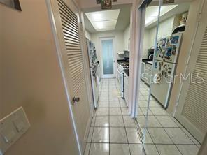 hallway featuring light tile patterned flooring