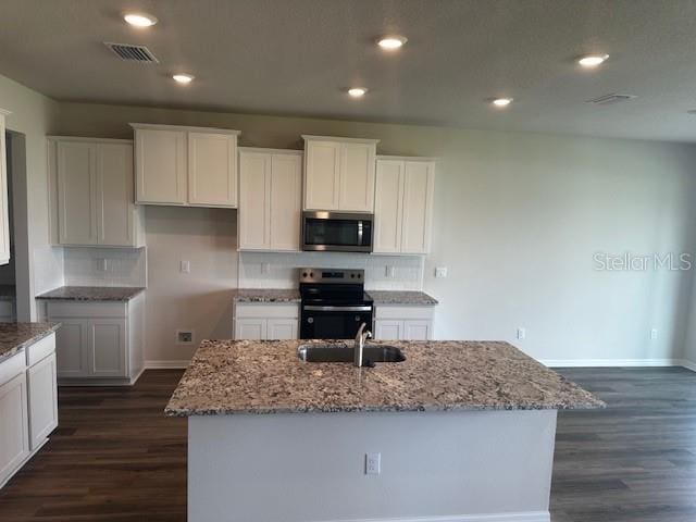 16025 7th Ave E, Bradenton, FL 34212 - kitchen with stainless steel microwave, electric stove, a sink, light stone countertops, and recessed lighting