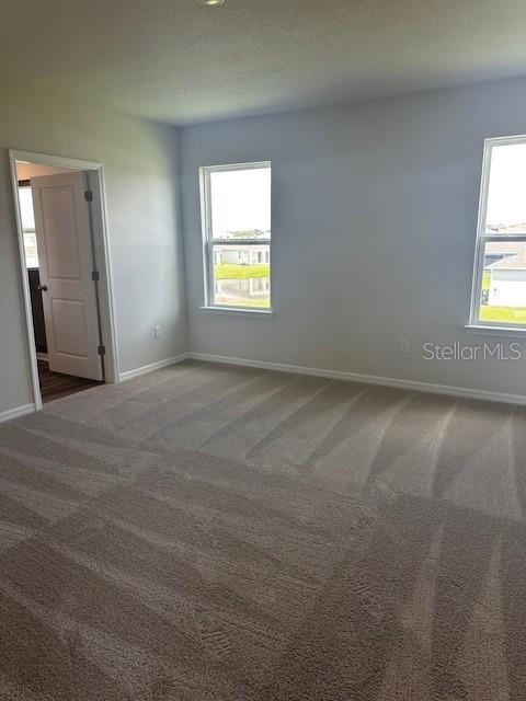 16025 7th Ave E, Bradenton, FL 34212 - carpeted empty room featuring baseboards